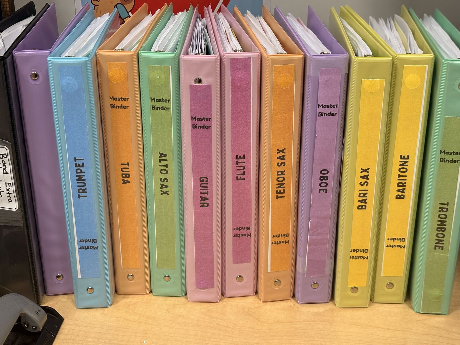 Sarah’s colour-coded master binders organized by band instrument