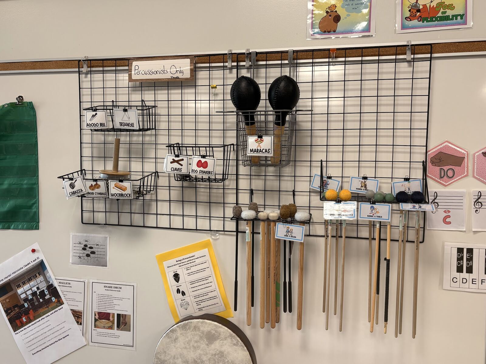 Sarah's labelled percussion wall with mallets and auxiliary percussion stored visibly