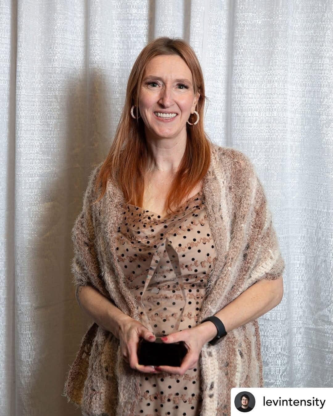 Sarah Batchelor holding an award